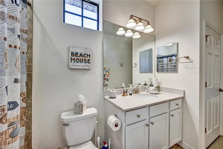 Full bath featuring a shower with curtain and vanity