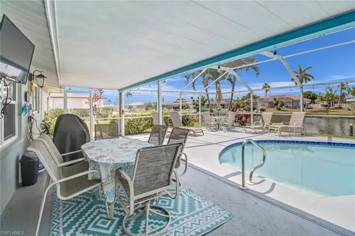 View of swimming pool featuring a patio area and a lanai