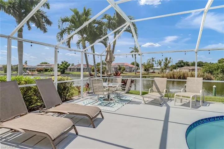 Sunroom / solarium featuring a water view
