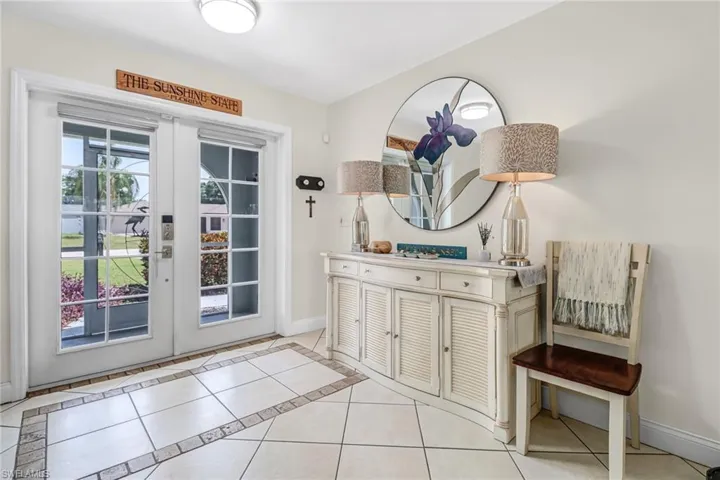 Entryway with french doors and light tile floors