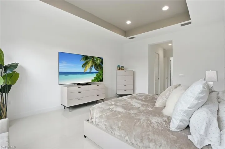 Tray ceiling featuring recessed lighting and smooth-finish flooring