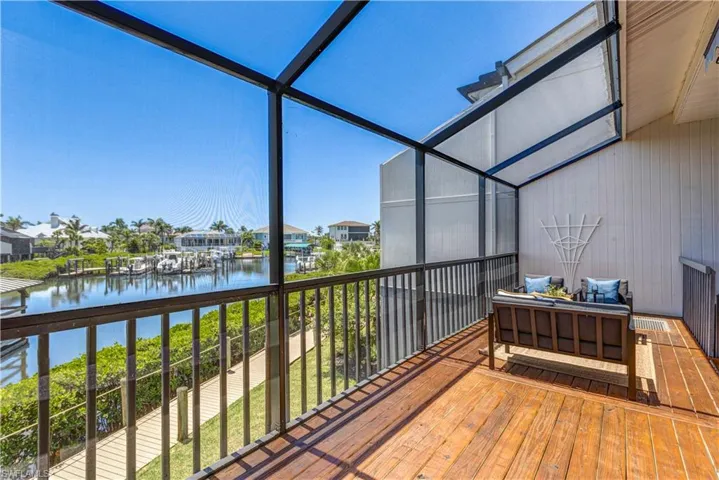 Screened lanai with marina and  water views.