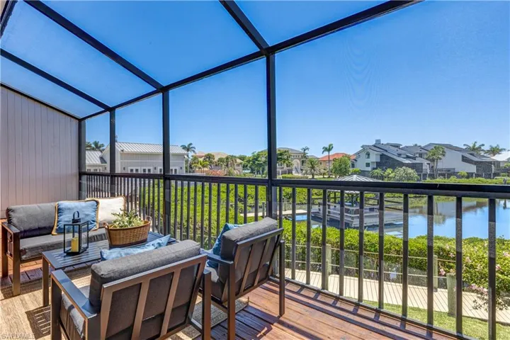 Enjoy outdoor living on this lovely screened balcony.