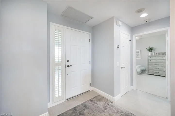 Foyer entrance with baseboards