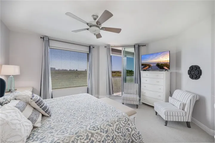 Bedroom featuring light colored carpet, access to outside, and ceiling fan
