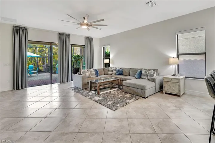 Tiled living room featuring ceiling fan