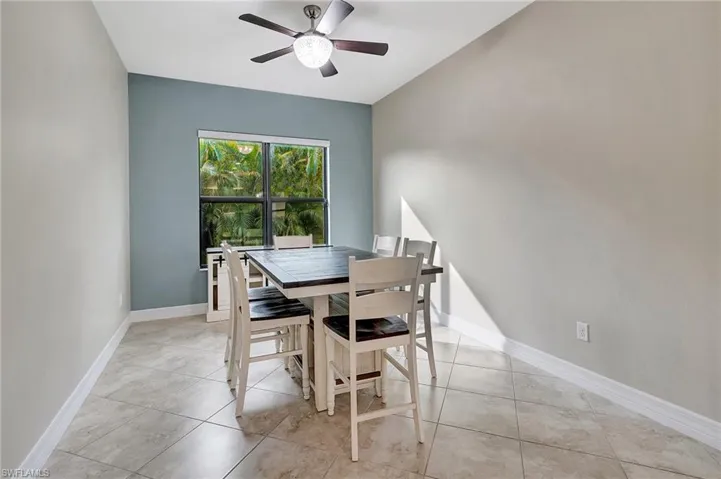 Tiled dining room with ceiling fan