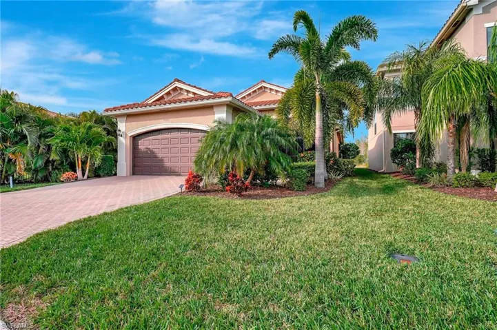 Mediterranean / spanish house featuring a front yard and a garage