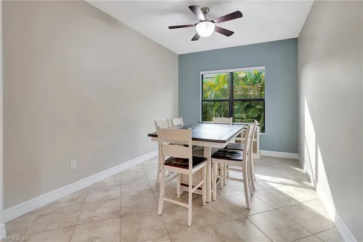 Dining room with ceiling fan and light tile patterned floors
