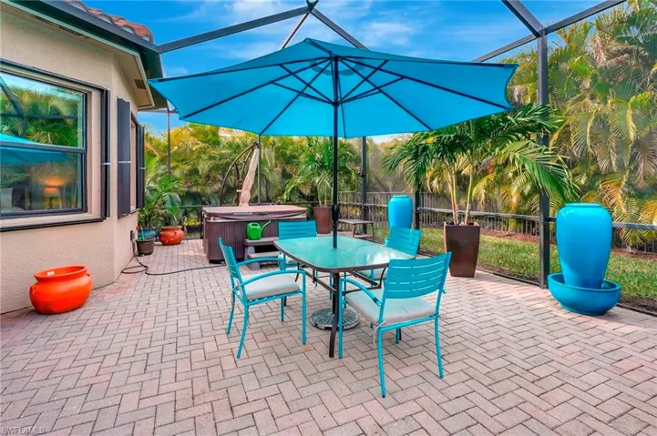 View of patio / terrace with glass enclosure and a hot tub