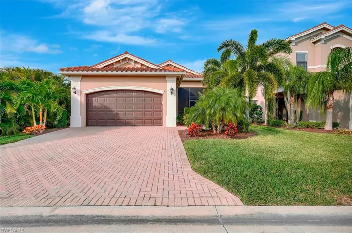 Mediterranean / spanish house with a garage and a front yard