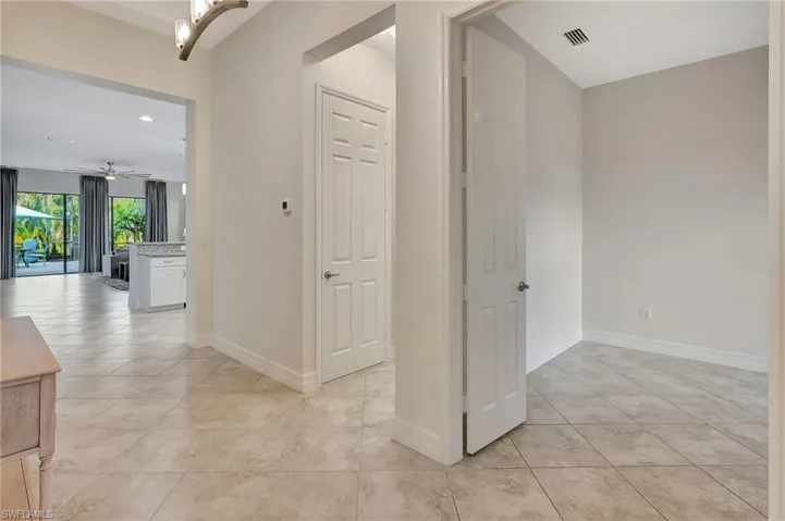 Hallway with light tile patterned floors