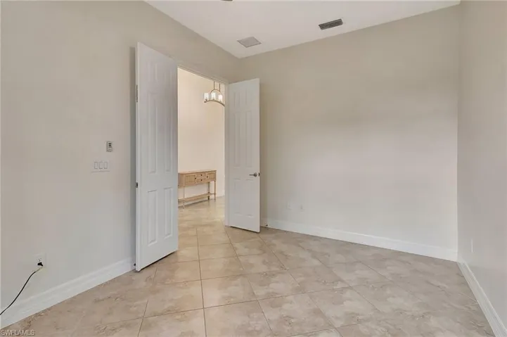 Empty room with light tile patterned flooring