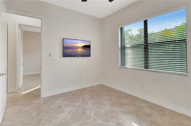 Unfurnished room featuring ceiling fan and light tile patterned flooring