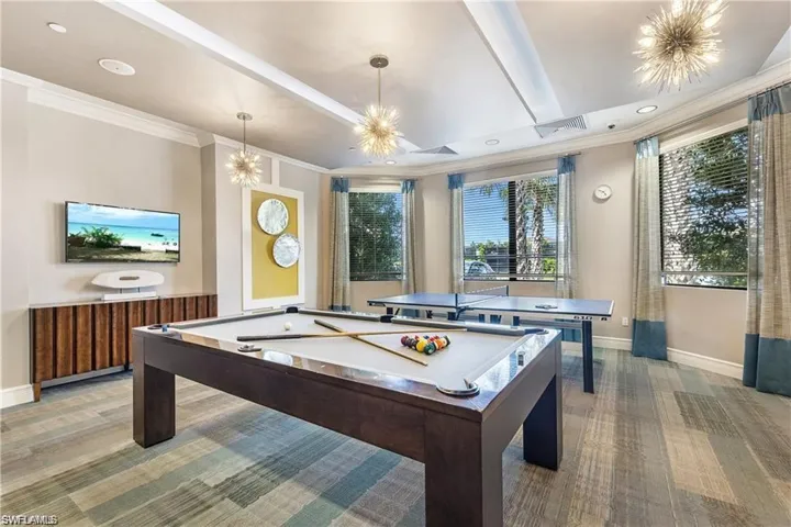 Game room featuring light colored carpet, billiards, an inviting chandelier, and crown molding