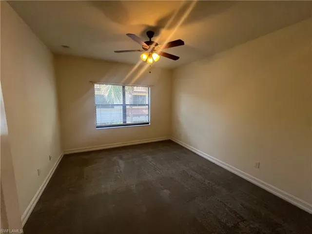 Unfurnished master bedroom with carpet and a ceiling fan