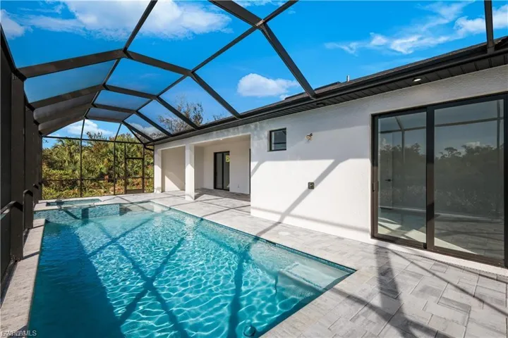 Viw of pool and spa; sliding door to Master bedroom at finished home.
