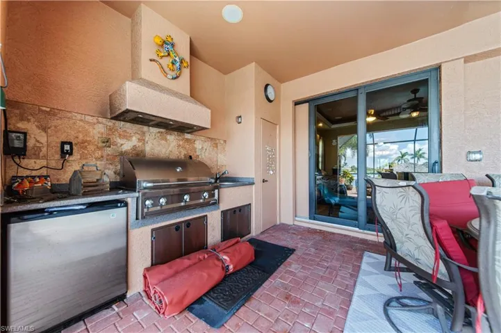 View of patio featuring an outdoor kitchen and a sink