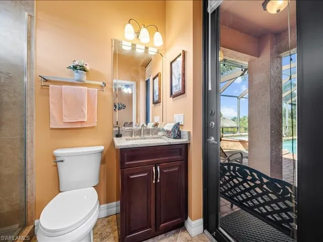 Bathroom featuring vanity and a tile shower
