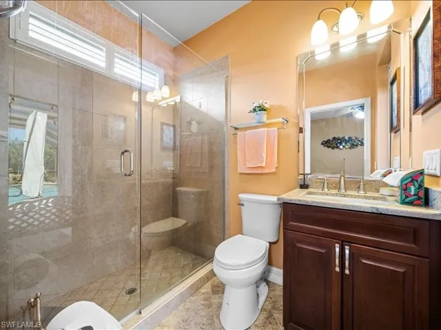 Bathroom with vanity, a shower stall, and light tile patterned flooring