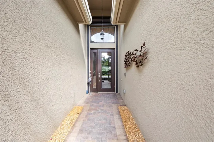View of exterior entry featuring stucco siding