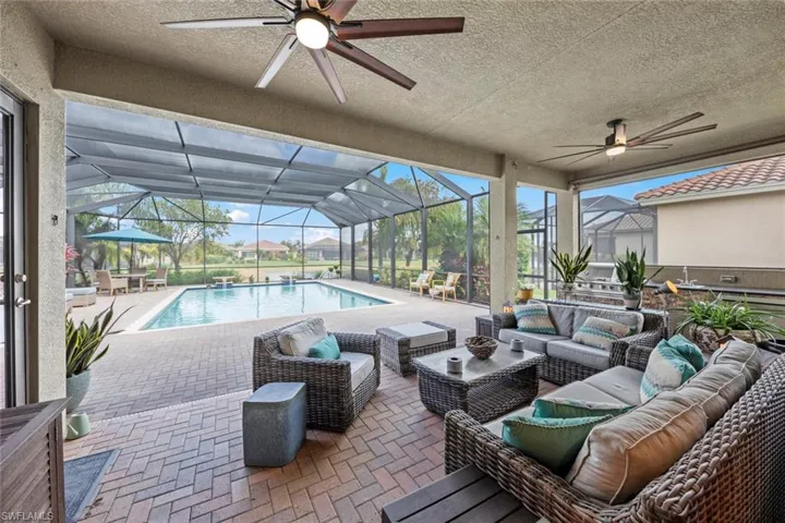 Outdoor pool with a ceiling fan, a lanai, a patio area, and an outdoor hangout area