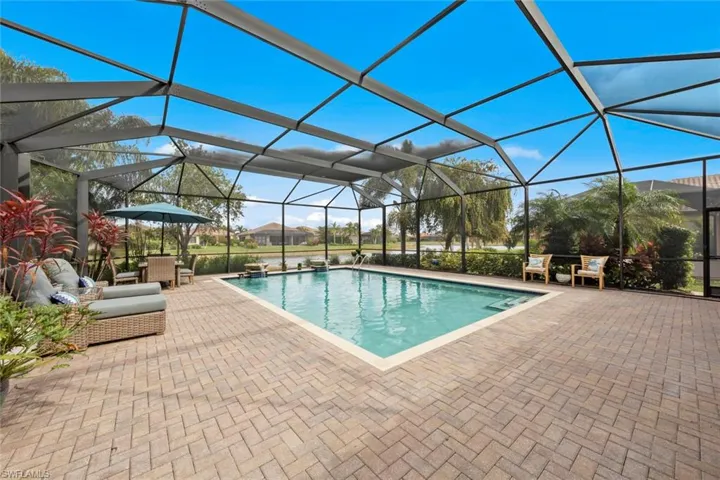 Outdoor pool with a patio area and screen enclosure
