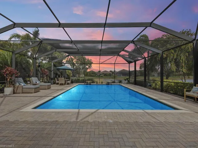 Outdoor pool with lanai enclosure and a patio