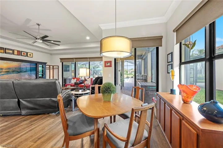 Dining room with a ceiling fan, ornamental molding, and wood finished floors
