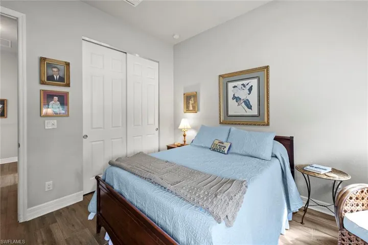 Bedroom featuring a closet, wood finished floors and baseboards