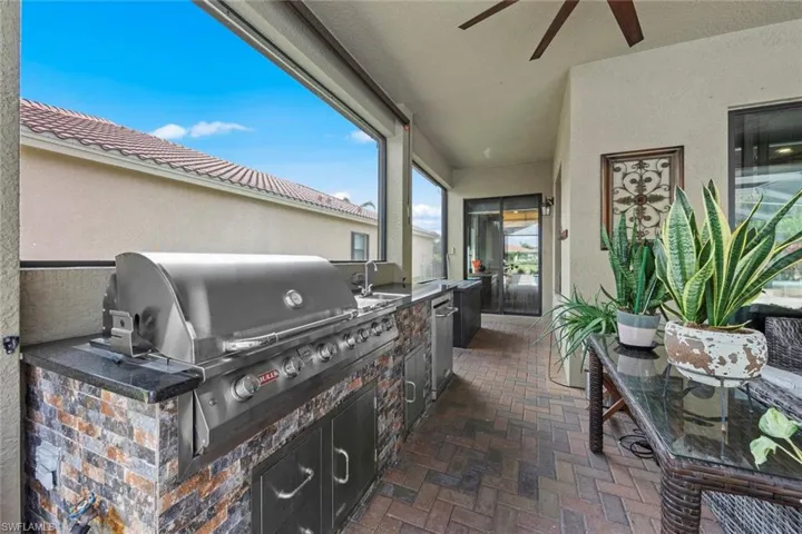 View of patio featuring ceiling fan, an outdoor kitchen, and area for grilling
