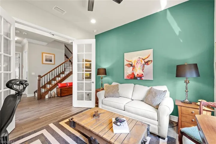 Den area with closet, wood finished floors, and French doors