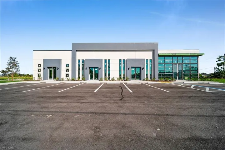 View of commercial location featuring uncovered parking
