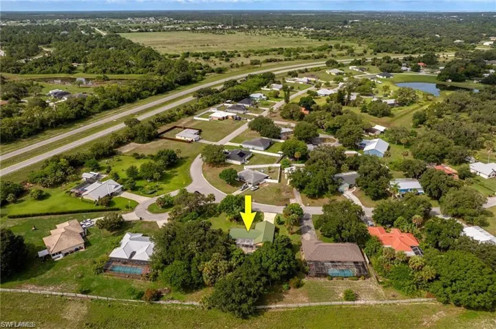 Aerial view of property and surrounding area with a large body of water and nearby suburban area