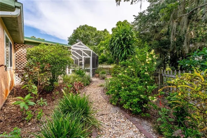 Fenced backyard featuring a lanai and a sunroom