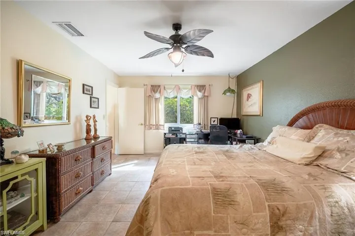 Bedroom featuring ceiling fan and light tile patterned flooring