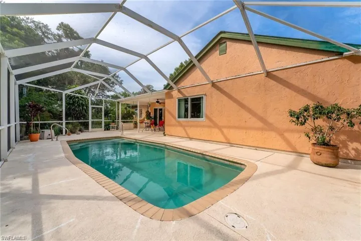 Outdoor pool featuring a patio, a sunroom, and a lanai