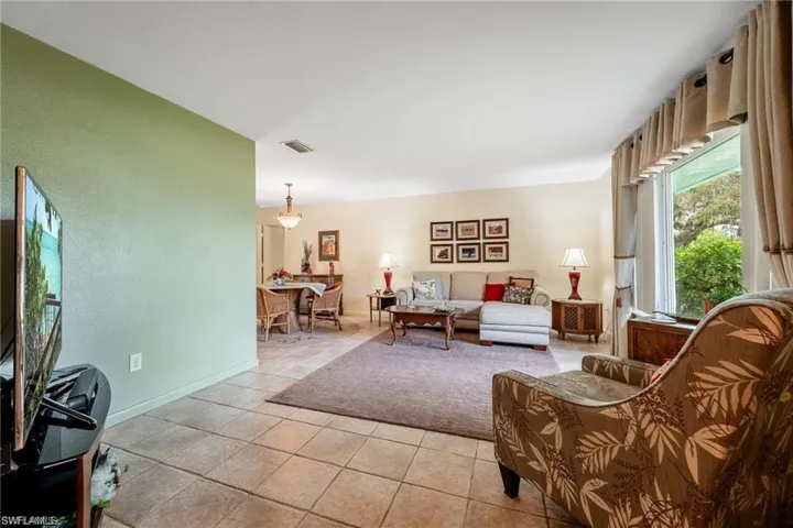 Living area with light tile patterned floors and baseboards