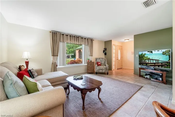 Tiled living room featuring baseboards