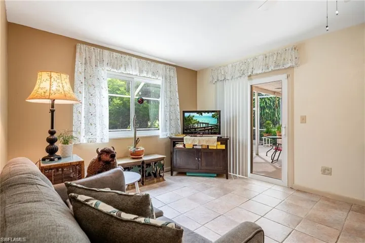 Living area featuring light tile patterned floors and baseboards