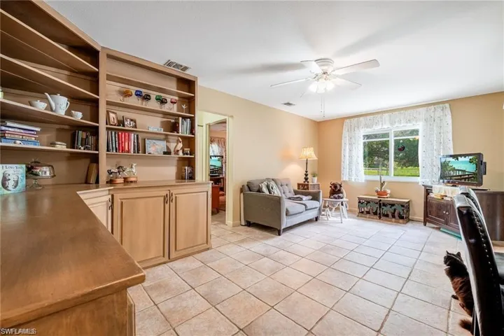 Office area featuring a ceiling fan and light tile patterned floors