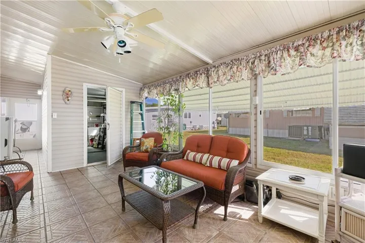 Sunroom / solarium featuring ceiling fan and lofted ceiling