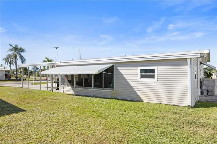 Back of property with a patio area and a yard
