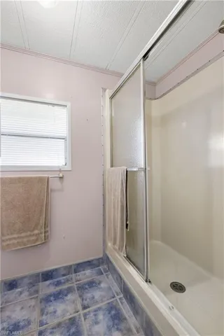 Bathroom with tile patterned floors, a textured ceiling, and walk in shower