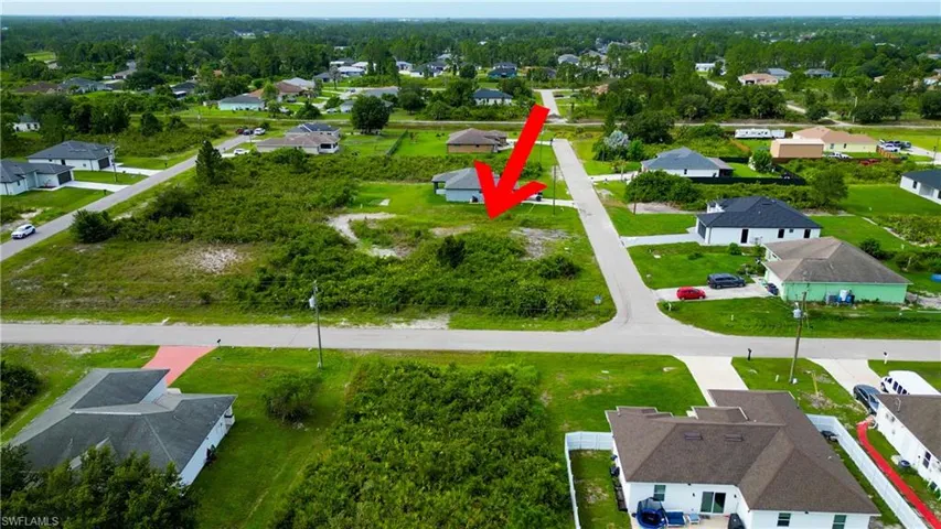 Expansive undeveloped lot featuring lush green vegetation and partial clearing