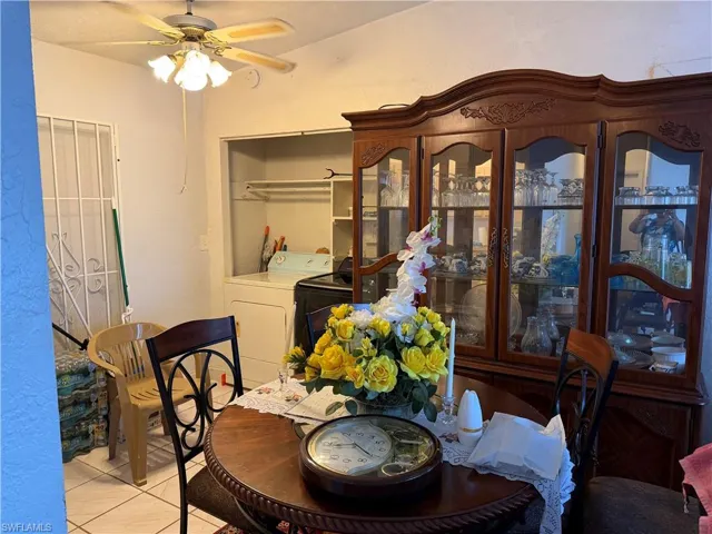 Dining room featuring light tile patterned floors and a ceiling fan