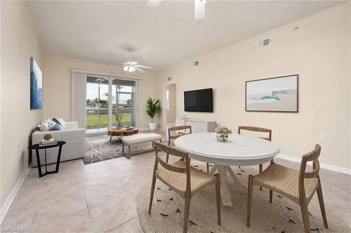 LIVING ROOM / DINING ROOM WITH LAKE VIEWS - PHOTO IS STAGED.