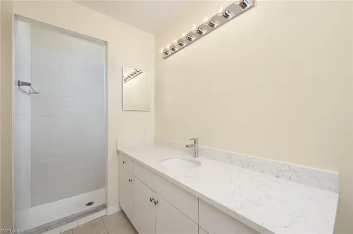 MAIN BATH WITH WALK IN SHOWER AND LARGE VANITY AREA.