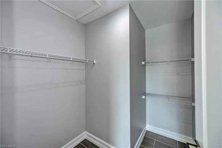 Spacious closet with dark tile floors