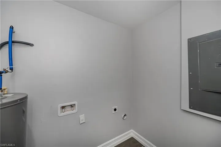 Washroom with hookup for a washing machine, electric water heater, and electric dryer hookup